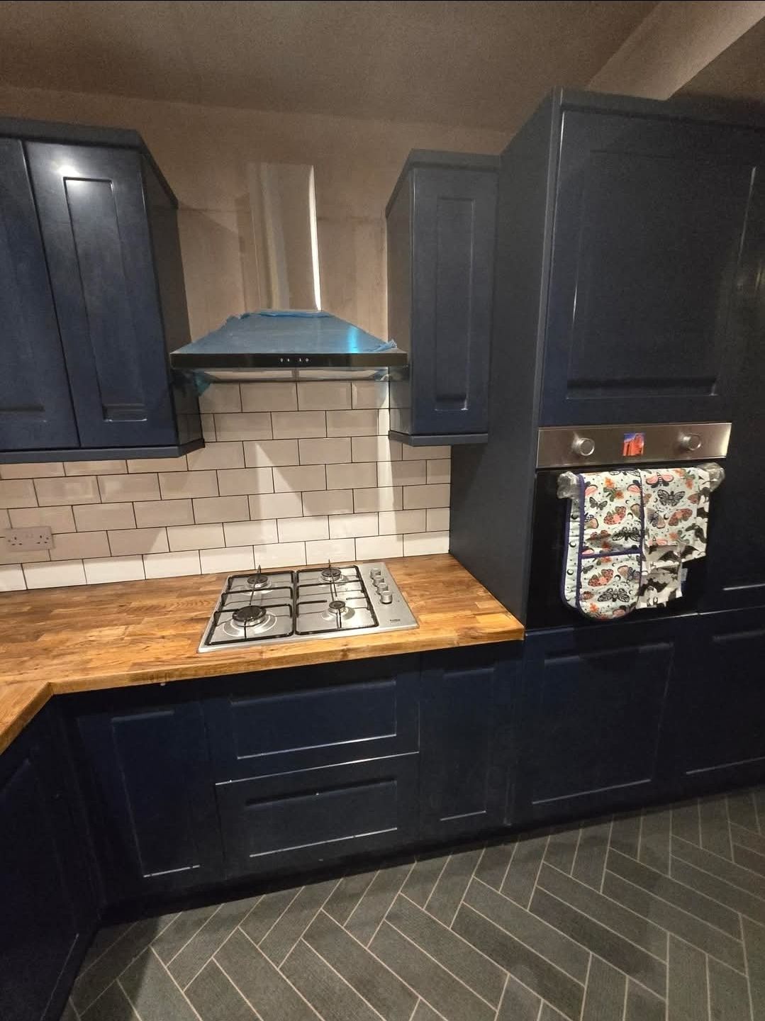 Modern white kitchen with LED accent lighting and dark worktops