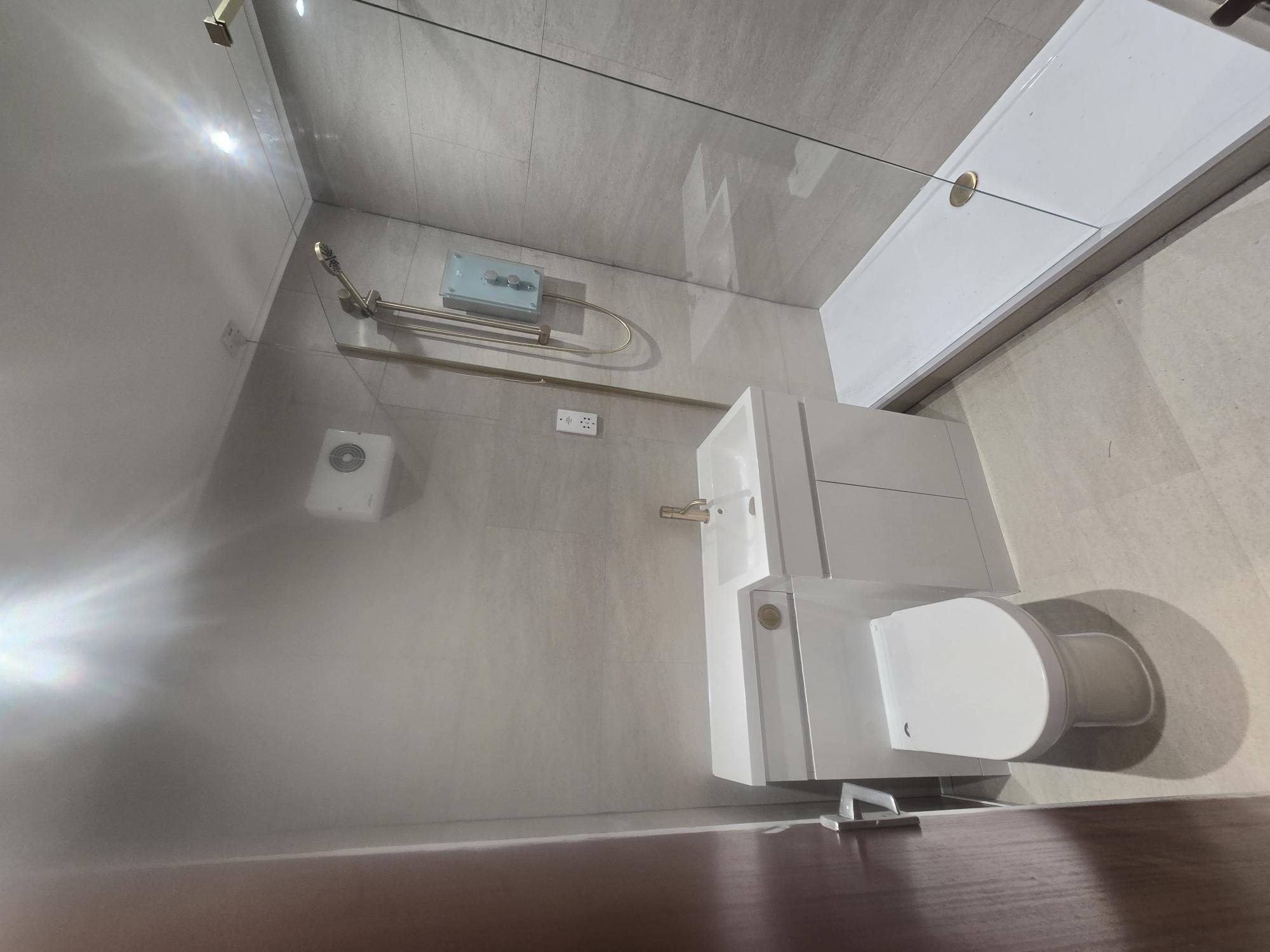 Modern white bathroom with vanity unit and gold fixtures