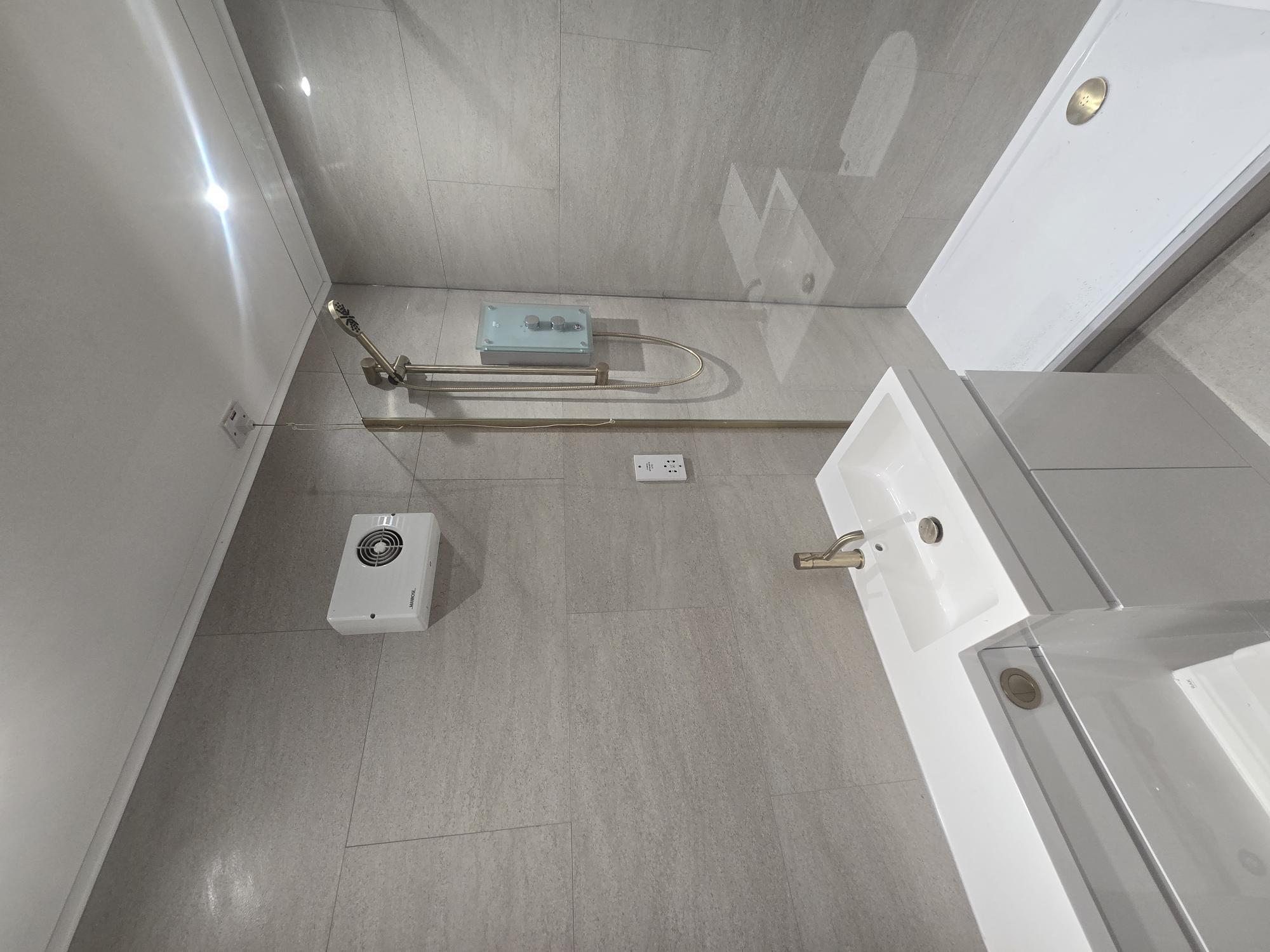 Bathroom fitting with basin and brushed gold taps