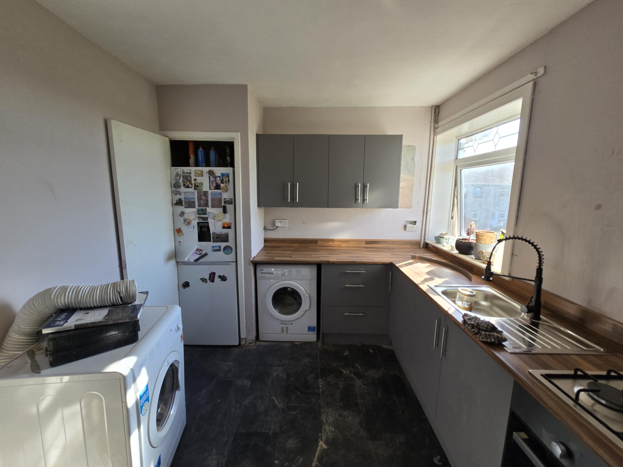 Grey kitchen fitting with wooden worktops