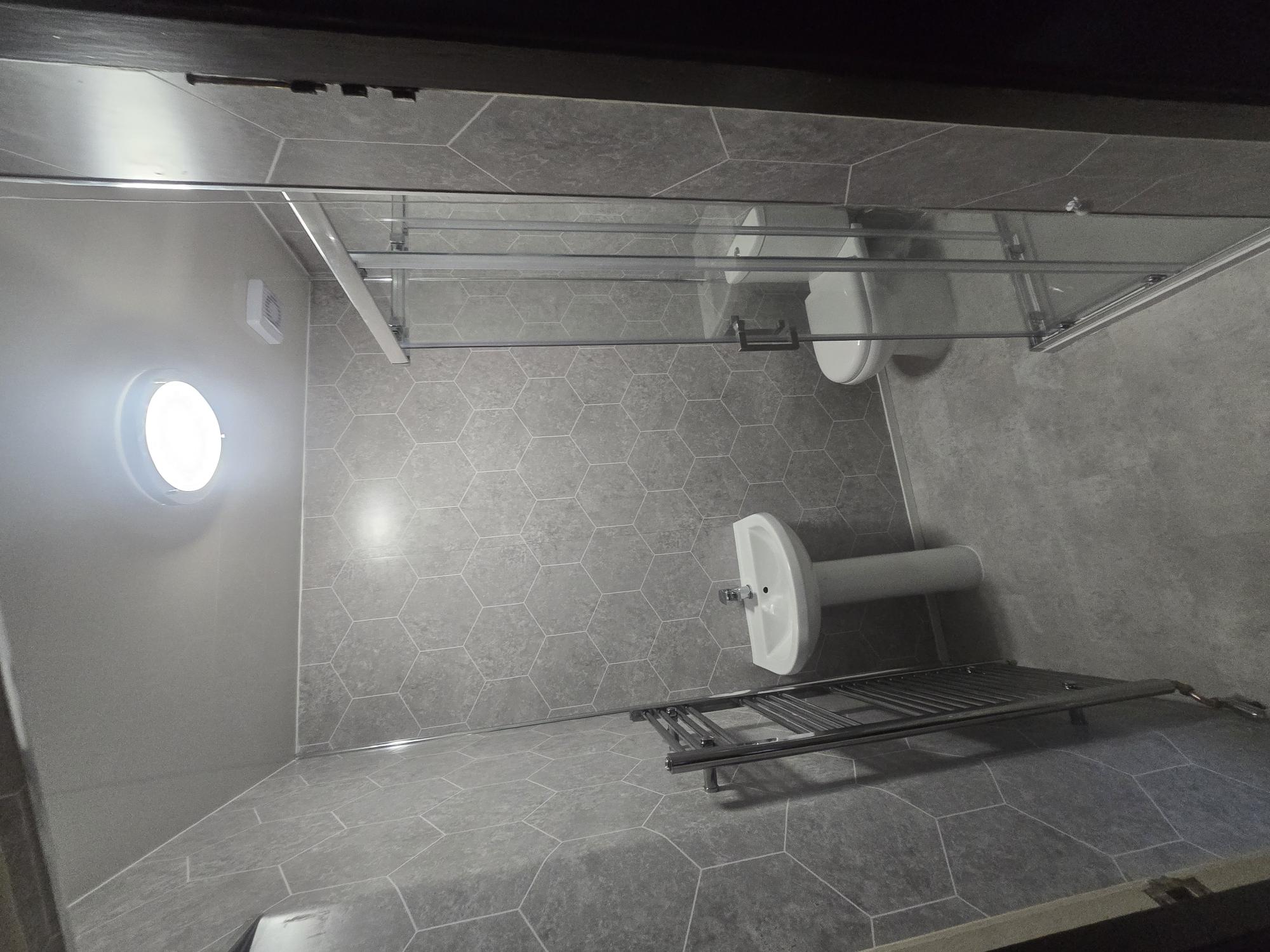 Bathroom with hexagonal tiling and walk-in shower