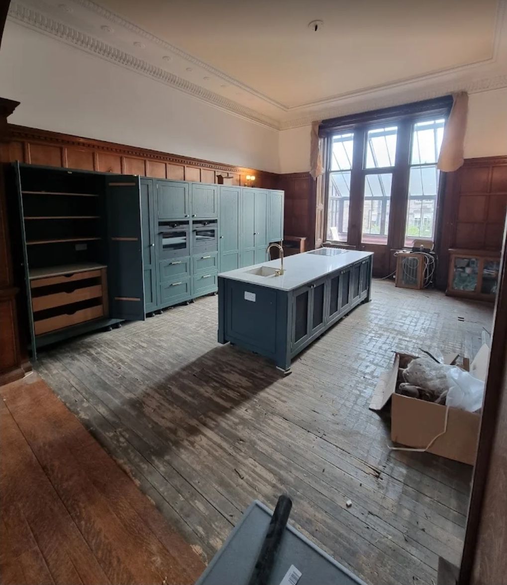 Bespoke teal kitchen with island in period property