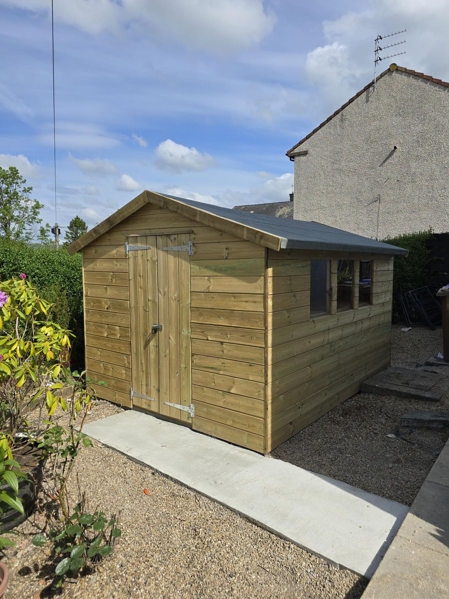 Garden building with decking and gate entrance